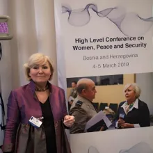 Speaking at the NATO High Level Conference on Women, Peace and Security, Sarajevo March 2019 in front of a poster featuring NATO Sir Stuart Peach and myself 