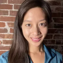 Asian American female wearing a teal shirt