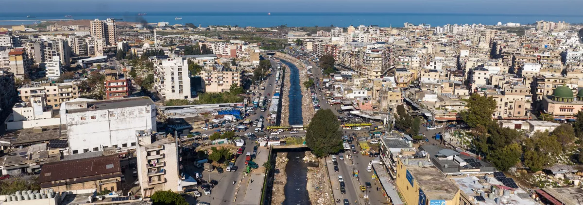 A body of water that has been contaminated by waste materials and pollutants / industrial zone / garbage on the streets depicts a scene of urban or residential areas that are strewn with litter and waste materials / traffic on a highway in Lebanon